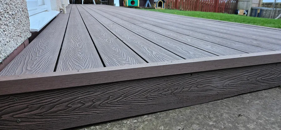 Composite decking boards installed on recycled plastic subframe joists
