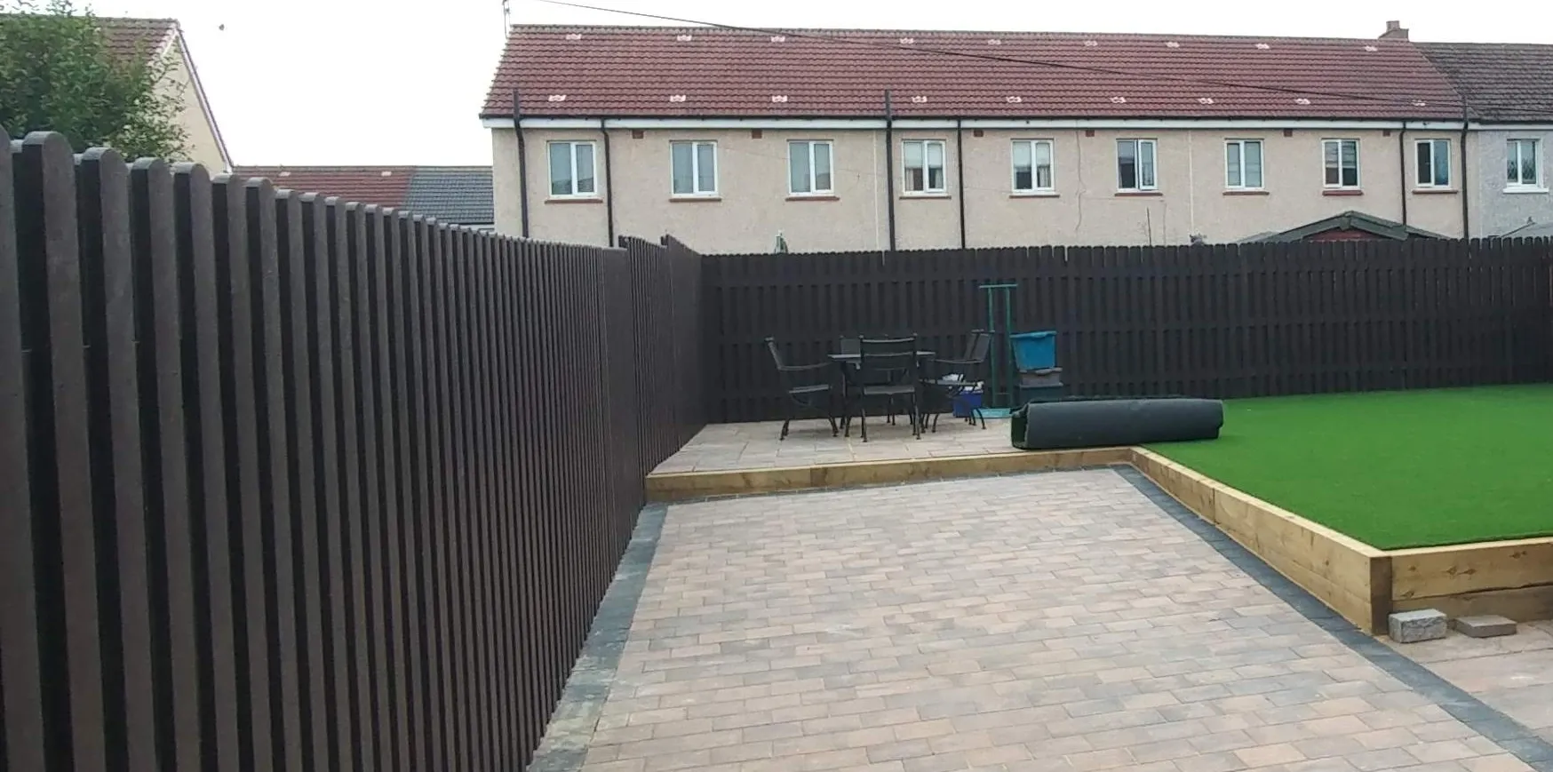 Completed garden with dark recycled plastic fence panels — Ezotrade UK