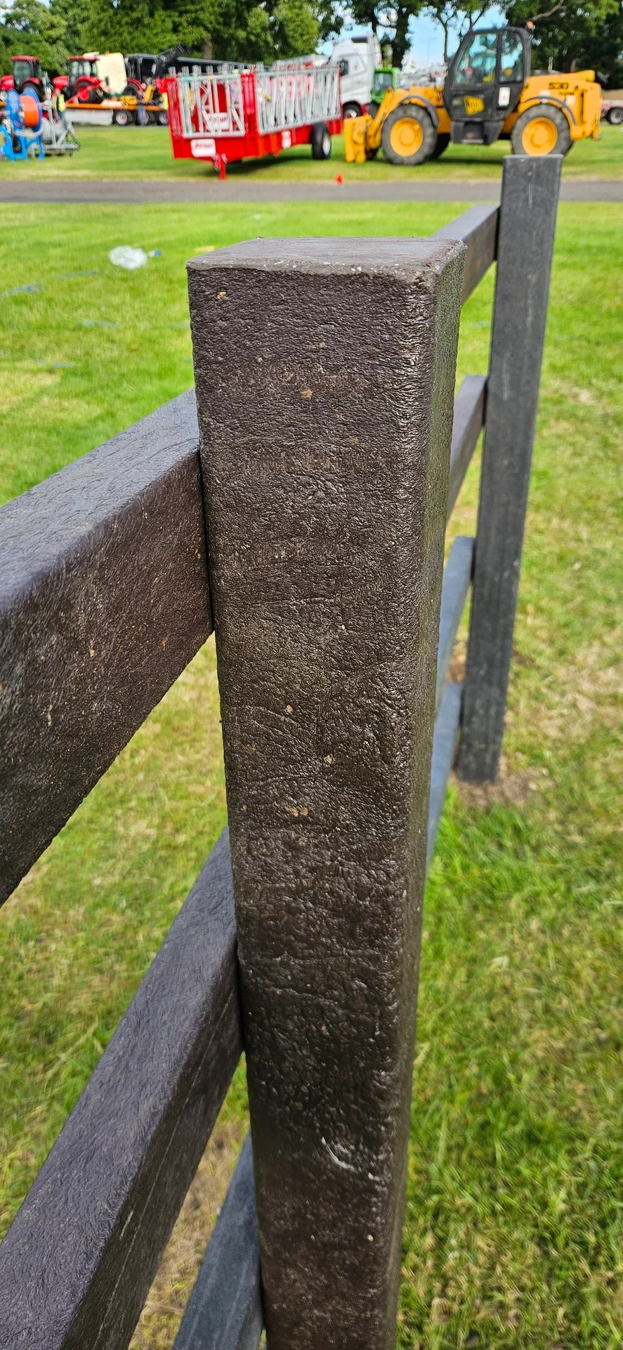 Close-up of black recycled plastic square fence post showing texture and material