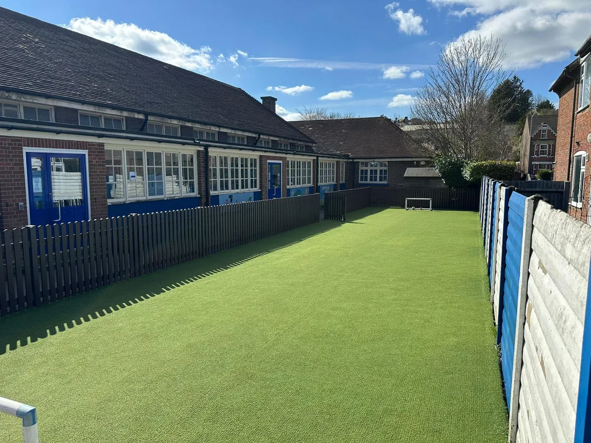 Recycled plastic picket fencing along the school playground perimeter