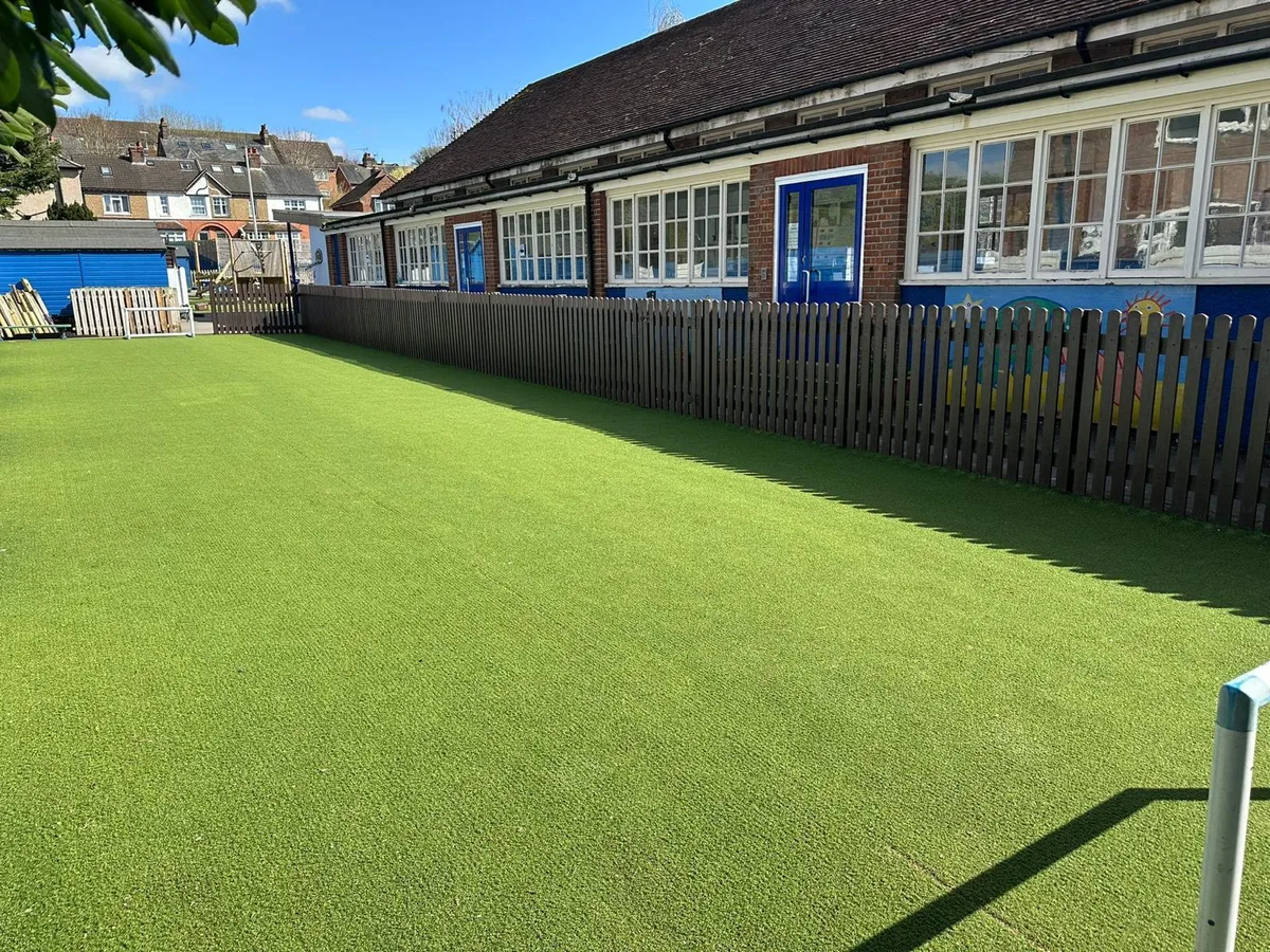 Recycled plastic fencing enclosing the school playground area