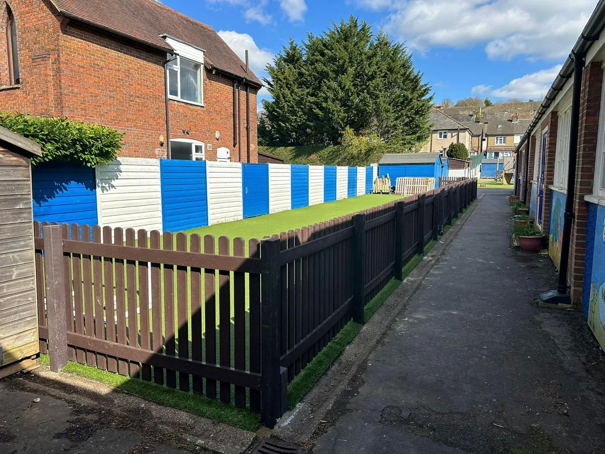 School pathway with recycled plastic fencing on both sides