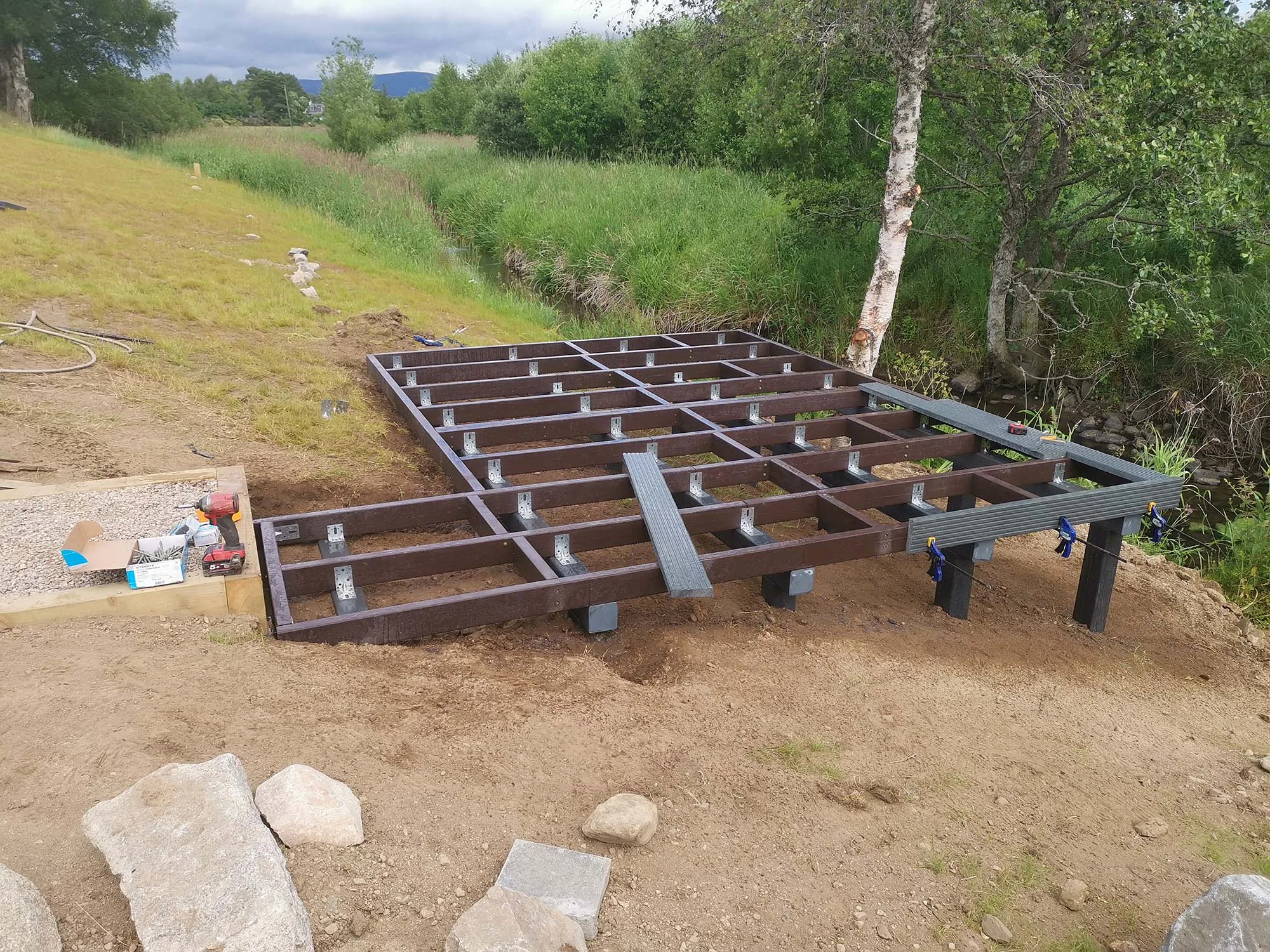 Recycled plastic decking subframe with joists installed on post supports