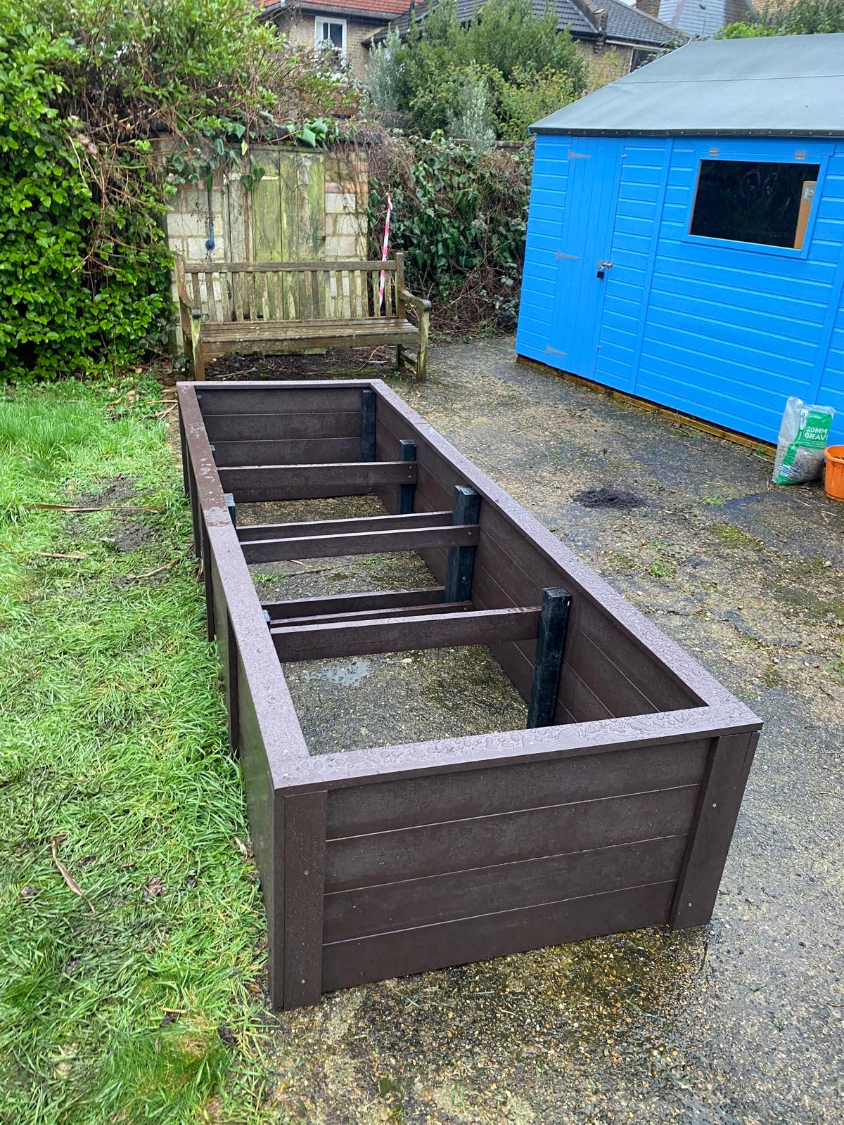 Internal bracket and divider structure of the recycled plastic planter showing steel fixings and internal joist supports