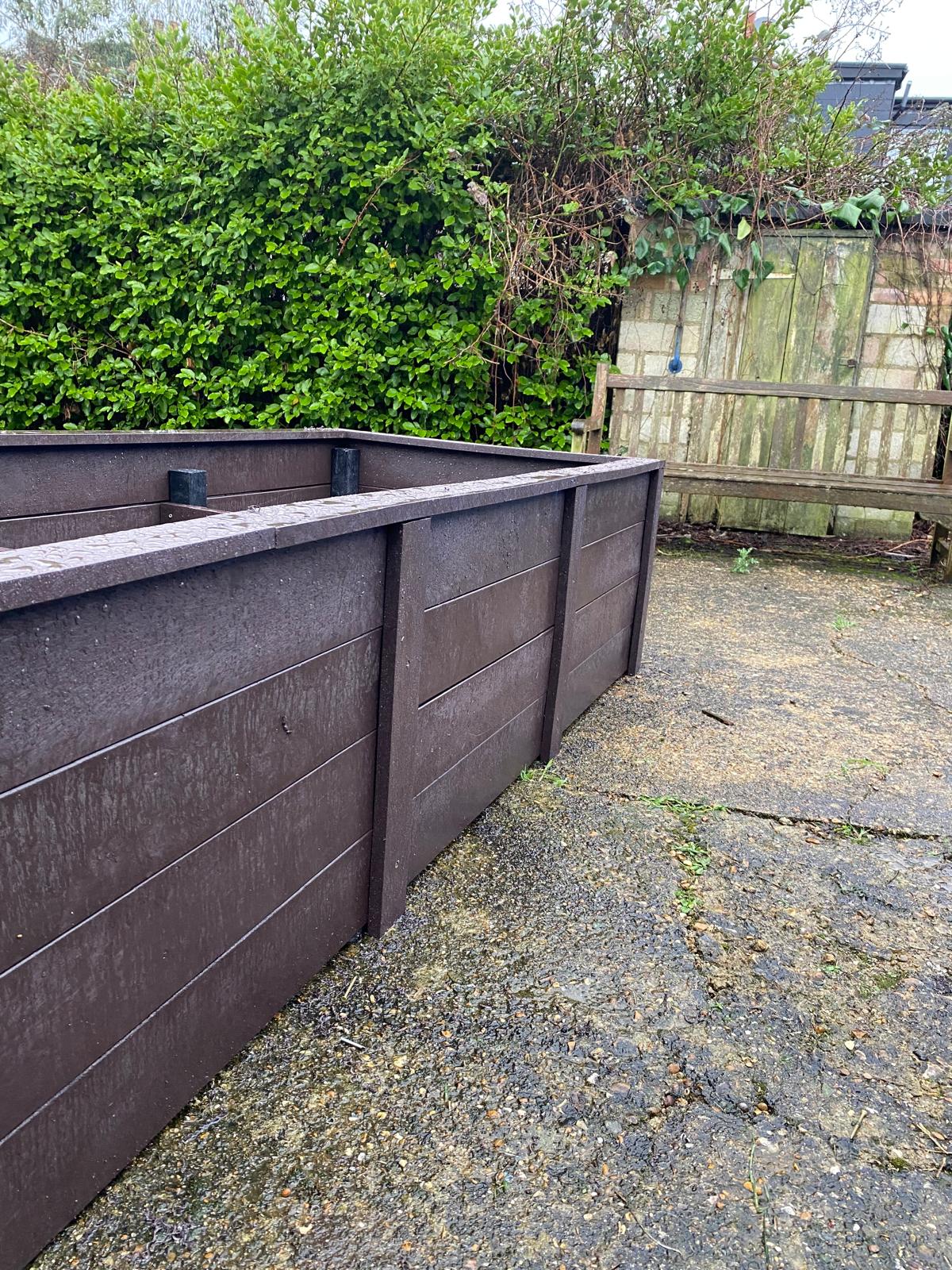 Side view close-up of the recycled plastic planter showing horizontal board detail and corner post construction